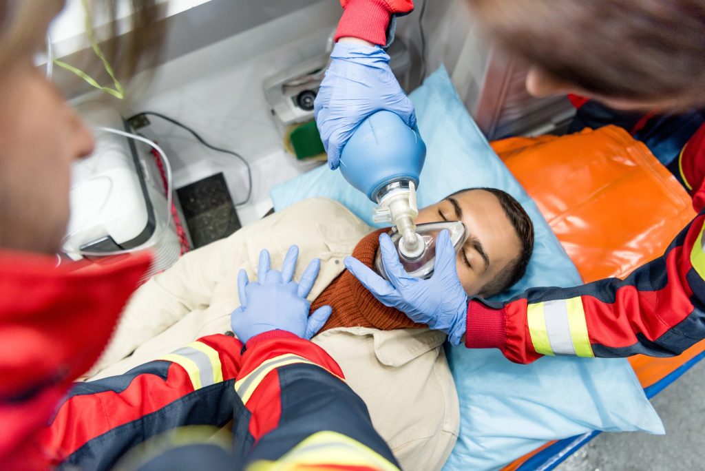 Paramedics performing cardiopulmonary resuscitation (CPR) on a young male patient; incapacitation can happen at any time.
