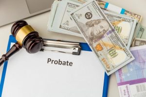 A file reading “probate” with a gavel and a stack of dollar bills sitting next to it; learning how to avoid probate can help preserve the value of an estate.