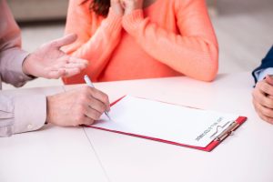 Florida probate attorneys examine estate documents as a woman goes through a death in the family.
